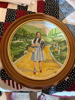 Dorothy from The Wizard of Oz on the Yellow Brick Road with Toto.