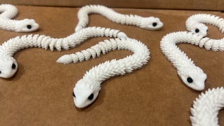 3d printed white articulated snakes