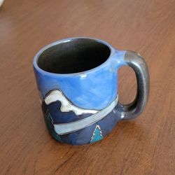 Mara Stoneware Snowy Mountains 16 oz mug.
This stoneware mug features a hand-etched, glazed mountain landscape 
design and is crafted in Mexico.
It is