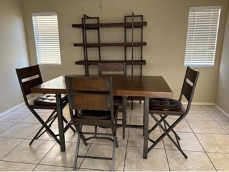 All wood and sculpted metal  kitchen table and matching breakfront shelves