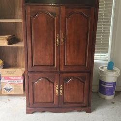Beautiful Armoire With Glass Shelves And Mirror Backsplash