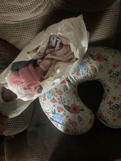 baby girl clothes and nursing pillow