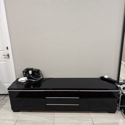 TV Stand in great condition, gloss black finish .