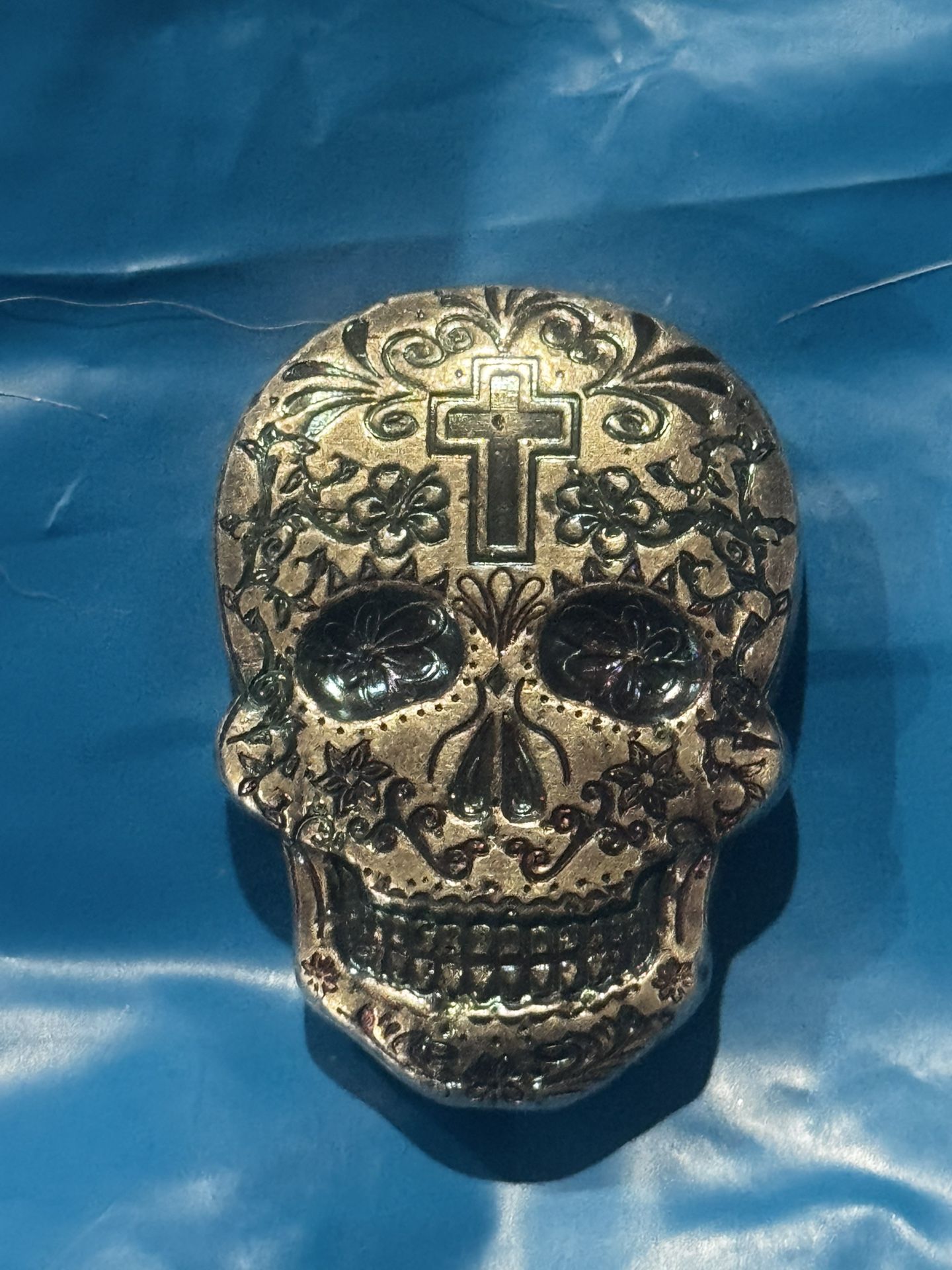This is a 2 oz silver sugar skull made by Monarch Precious Metals.