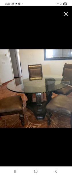 Dinning Room Set glass top fancy elegant with Leather Chairs solid wood chairs.  New condition  $375.  Moving .must sale