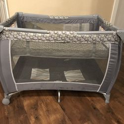Portable playpen with top bassinet