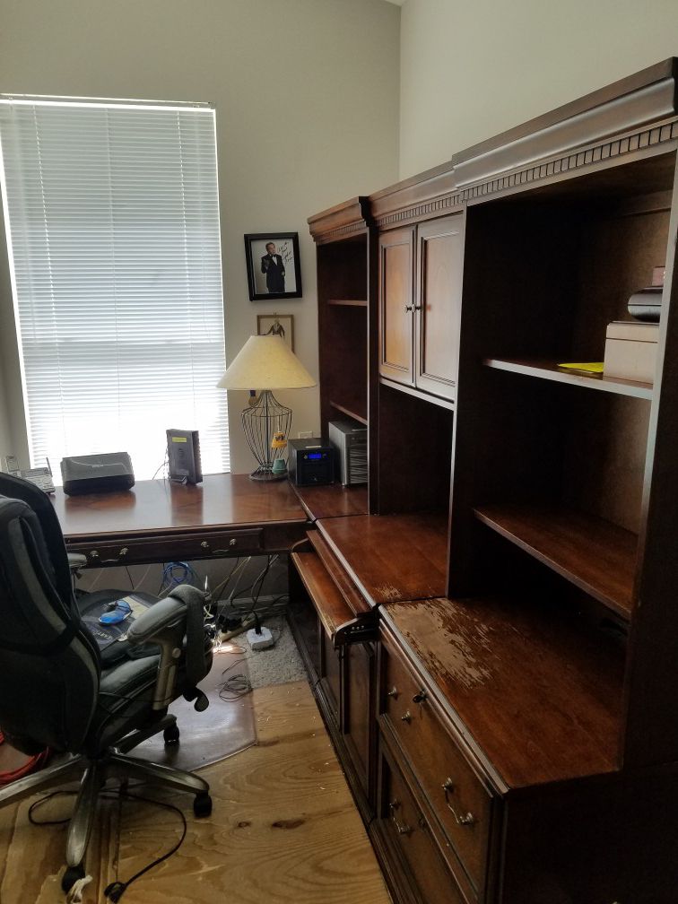 Desk with side shelves, cabinet and file cabinet.