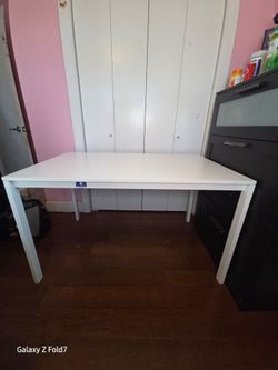 Ikea - Versatile white table. Great for a desk, dining, or craft area. Has a small sticker on side. Simple design, easy to match with any decor.
49 1/
