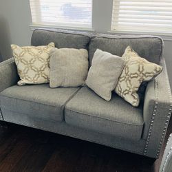 Modern Gray Loveseat with Nailhead Trim + Pillows - Ashley Furniture