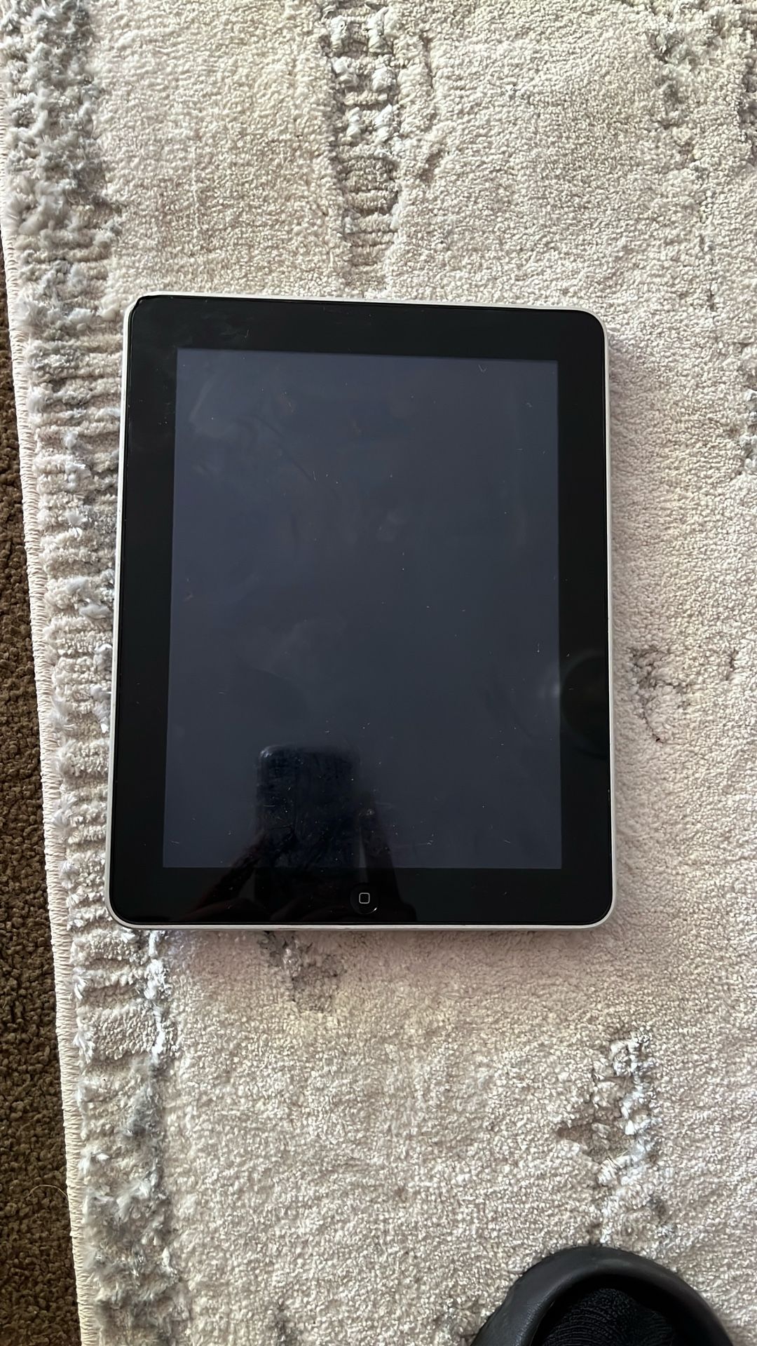 First generation iPad. Works Perfectly With Charger Included. Has A Little Dent In One Corner