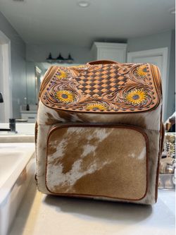 Cowhide and tooled leather backpack
