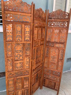 An vintage Indian carved teak wood folding room divider screen.