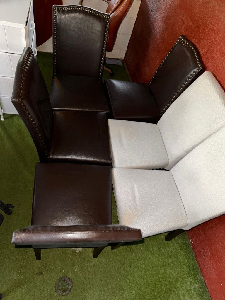 A set of six dining chairs with a mix of black and light gray upholstery, featuring nailhead trim and wooden legs. $400  New cash and pickup