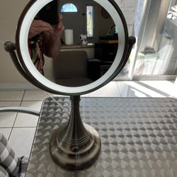 Double-sided magnifying mirror with light in good condition and clean