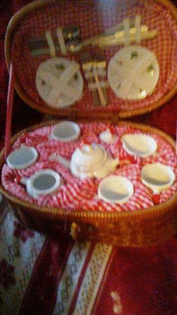 Antique basket with complete tea party set up