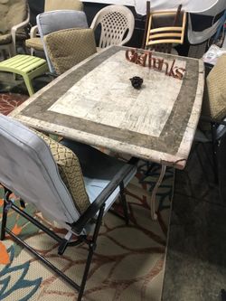 Table and chairs with blue umbrella