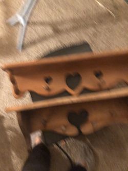 Two wooden shelves with hooks for hanging