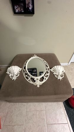 vintage white and gold-trimmed ornate Syroco wall mirror and matching sconce shelf set features