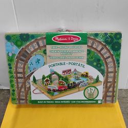 Melissa & Doug Take-Along Railroad, a portable 17-piece wooden train set designed for tabletop play.