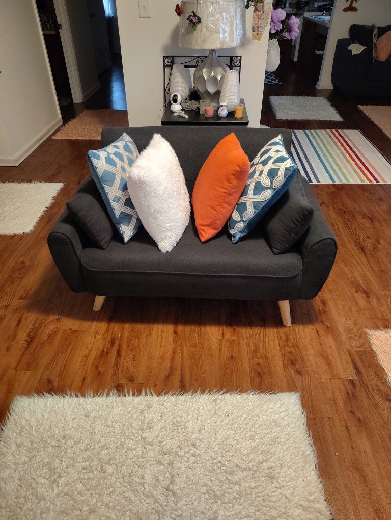 A CUTE BLUE SOFA CAN HOLD UP A 300 _ 50_ POUND PERSON