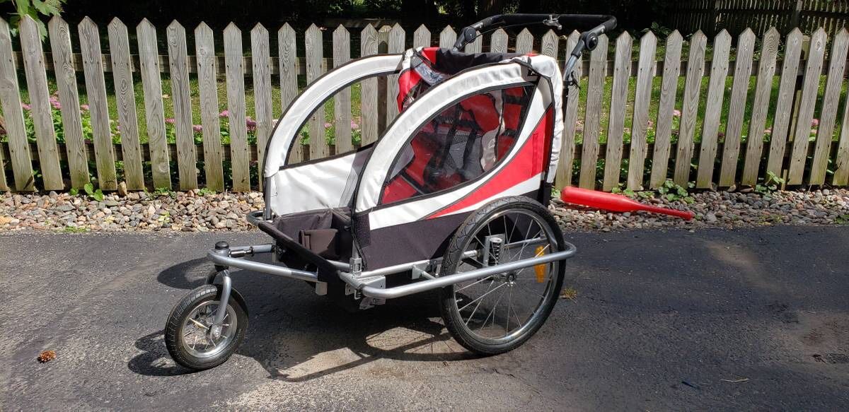 2 kid bike trailer. Works as a bike trailer or stroller. It is like new, nothing is wrong with it. It does not break down smaller for storage. Origin