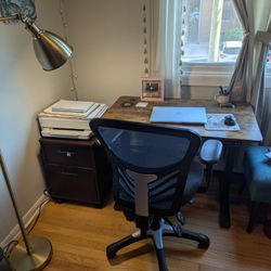 Home Office Setup with Adjustable Height Desk, Chair, and File Cabinet