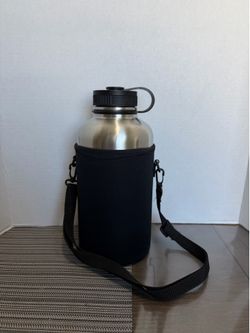 Brand new  64 oz stainless steel insulated water bottle with sleeve carry strap