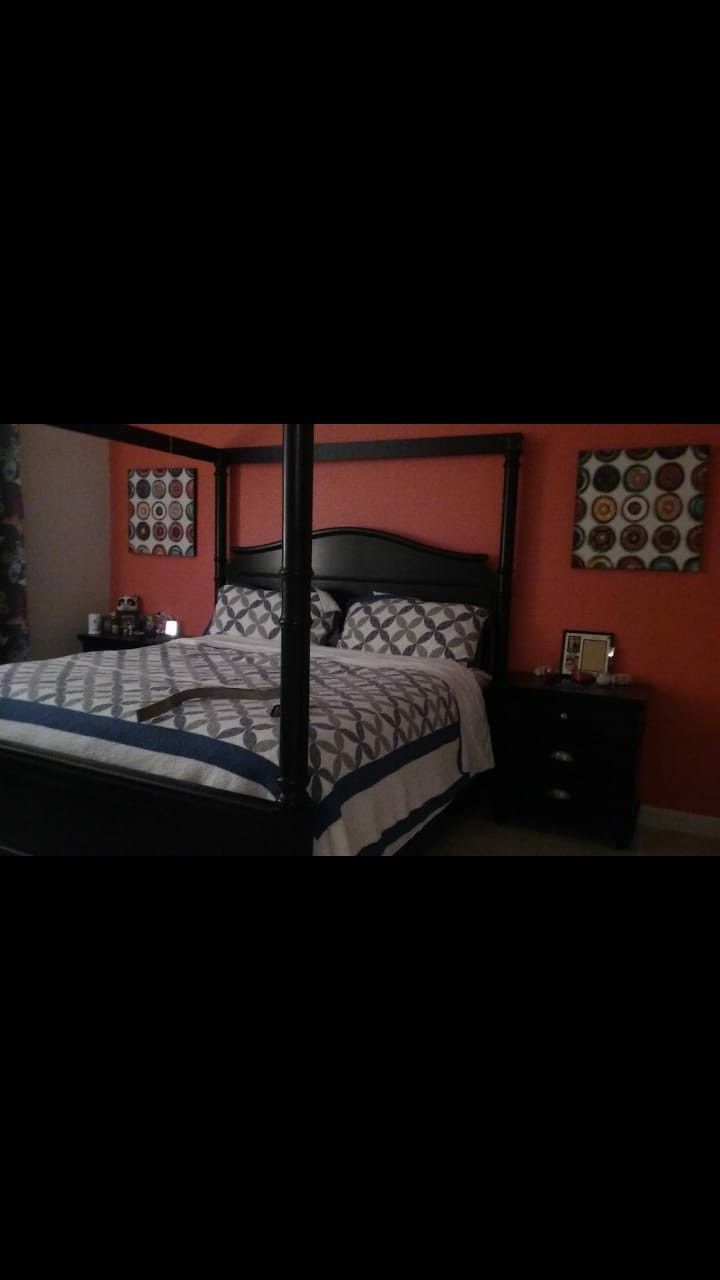 Badcock: King size Black Canopy Bed with 2 night stands.