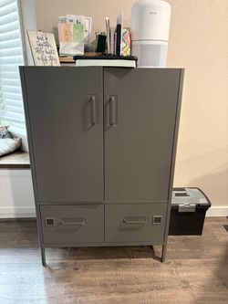Metal cabinet with filing drawers