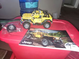 Bucket of Legos with some sets and books