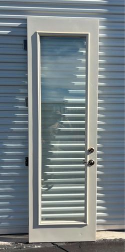 30”x95” Full-lite single exterior door with a tall narrow window pane.Hardware: Equipped with a matching handle set and deadbolt.