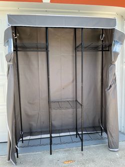 Portable metal storage closet with a zippered cover to keep out dust; includes a hanging rail. It measures 76 inches high, 57 inches wide, and 16 inch