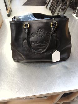 This is a Prada Glacé Calfskin Embossed Logo Tote in black leather. 