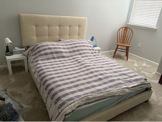 Queen bed with mattress and linens