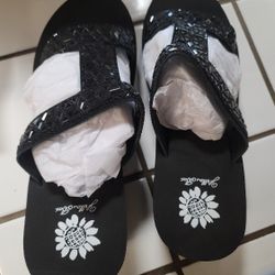 Brand new. Yellow box eastern black wedge sandals. Size 8m.