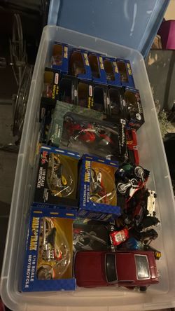 Box of diecast model cars and motorcycles.