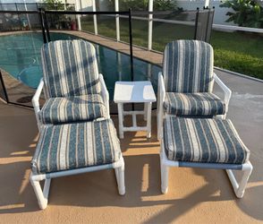 Two reclining patio chairs with ottomans