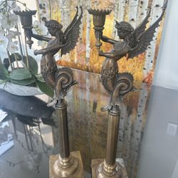 A pair of bronzed candlestick holders