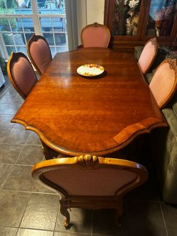 Dining table and six chairs and two center leaves