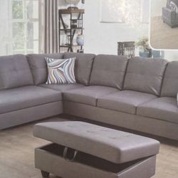 Gray leather sectional couch and ottoman
