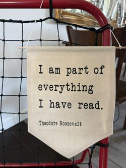 Canvas wall hanging banner features a famous typewriter-font quote by former U.S. President Theodore Roosevelt