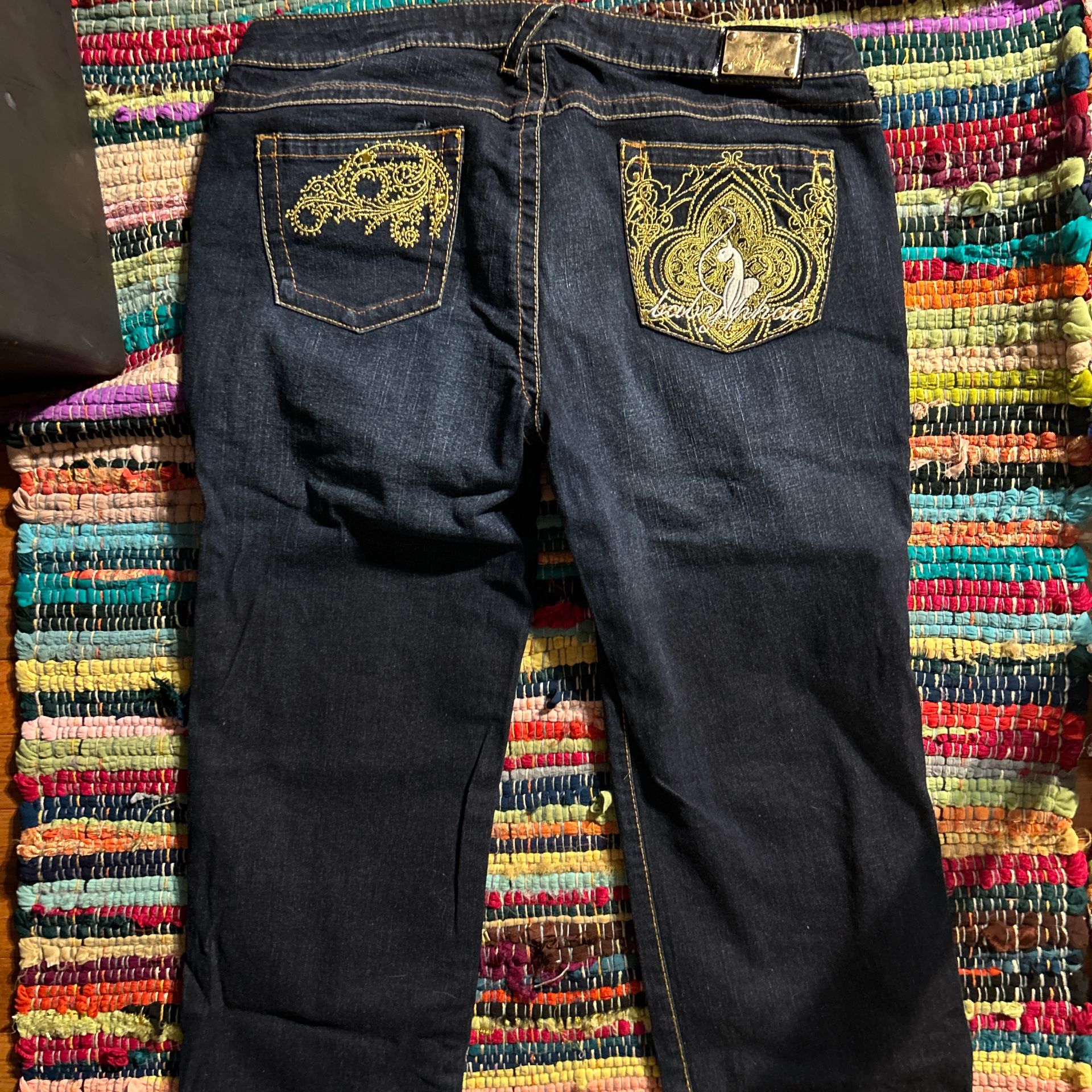 Size 15 Dark Wash Straight Leg Baby Phat Jeans With Unique Gold Detailing On The Back Pocket.