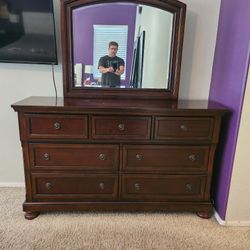 Ashley Porter 7 Drawer Dresser & Mirror. Asking $500 obo. Details and dimensions in photos. Set of two matching nightstands available also. 