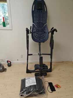 Teeter inversion table with massage pad