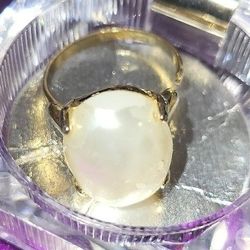 Adjustable Pearl (Faux) Ring. Stone has Some Slight Peeling that Exposes the Actual stone Underneath.  Still very Pretty.