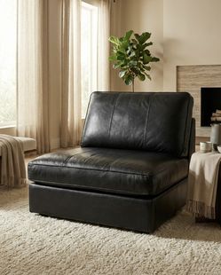 Black Faux Leather Lounge Chair – Modern and versatile, can be used as a standalone chair or as part of a sectional.
