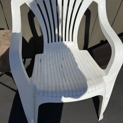 White plastic chair with arm rests