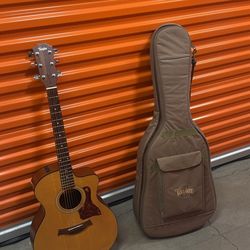 Taylor acoustic guitar with a soft Taylor gig bag