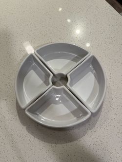 Four piece porcelain serving dish set forms a circular arrangement