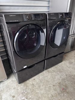 Black stainless Samsung - 5.0 Cu. Ft. High-Efficiency Front Load Washer and front load Samsung dryer 7.5 cu.ft  with pedestals